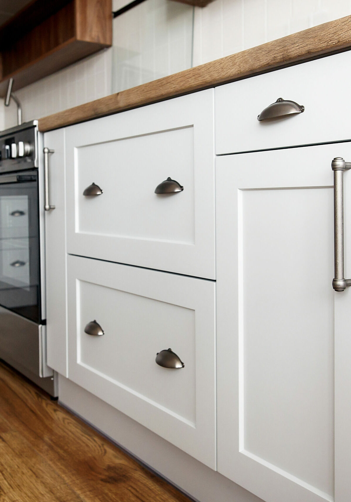 Stylish light gray handles on cabinets | Floor to Ceiling